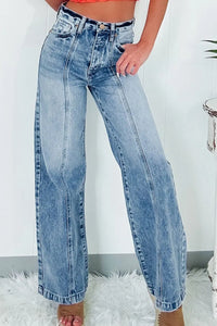 Blue jeans worn by a person on a white background