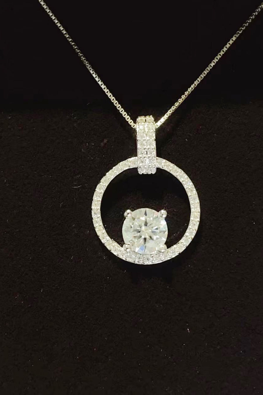 Diamond pendant necklace on a black background