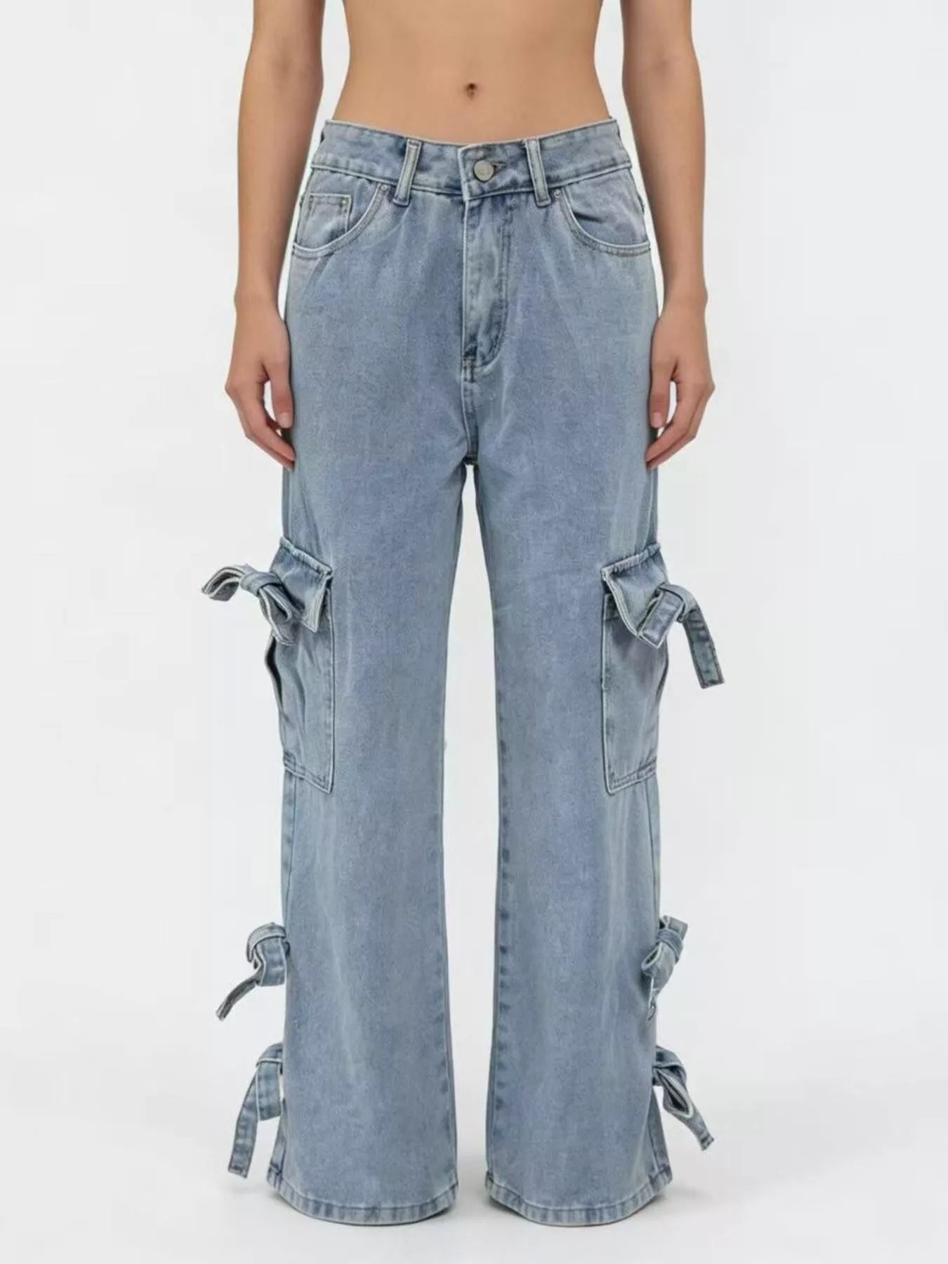 Light blue denim pants with tie details on a white background