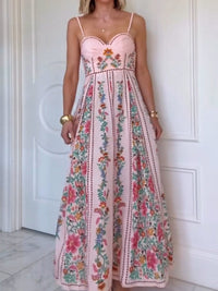 Woman wearing a pink floral dress against a white door.