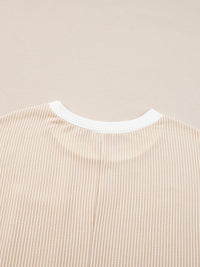 Close-up of a beige and white striped shirt collar on a beige background