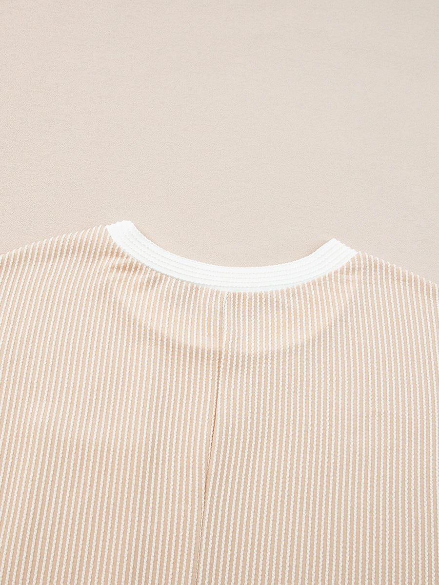 Close-up of a beige and white striped shirt collar on a beige background