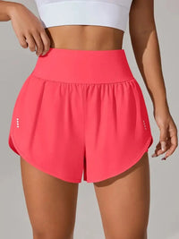 Person wearing pink athletic shorts on a plain background