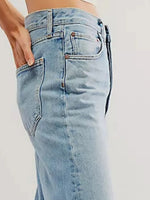 Light blue jeans worn by a person on a white background