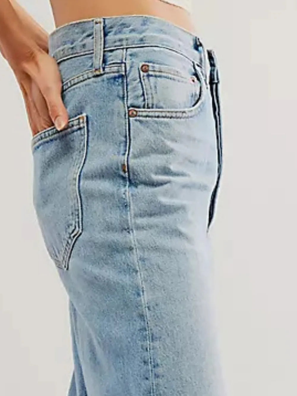 Light blue jeans worn by a person on a white background