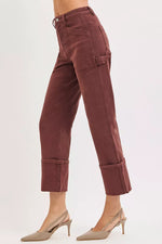 Brown pants worn by a person on a white background