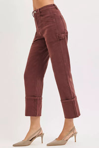 Brown pants worn by a person on a white background