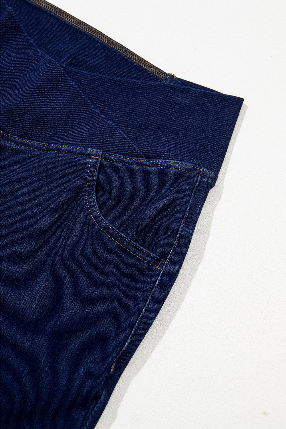 Close-up of a blue denim fabric with a white background