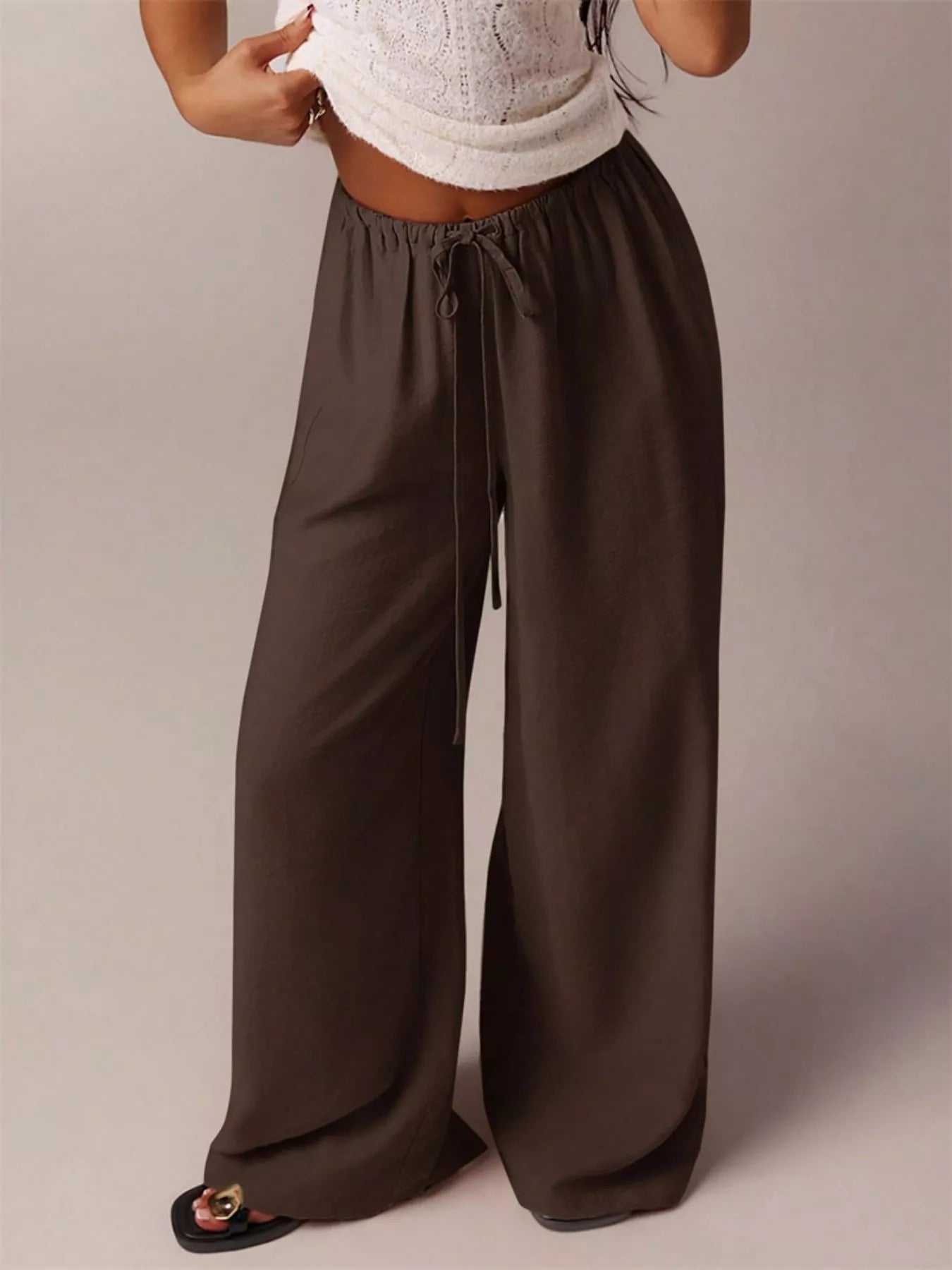 Brown wide-leg pants worn by a person on a plain background