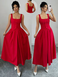 Woman wearing a red dress with a gray background