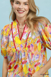 Woman wearing a colorful floral dress against a light blue background