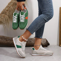 Person wearing green and white sneakers with a neutral background