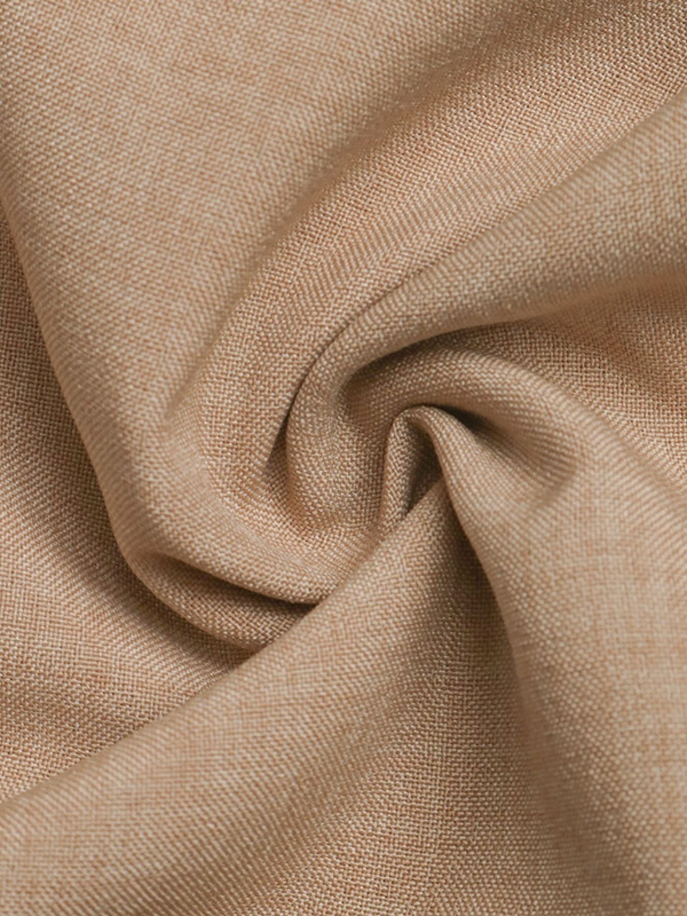 Close-up of beige fabric with a textured pattern