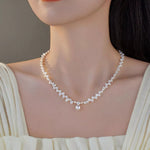 Pearl necklace worn by a model against a neutral background