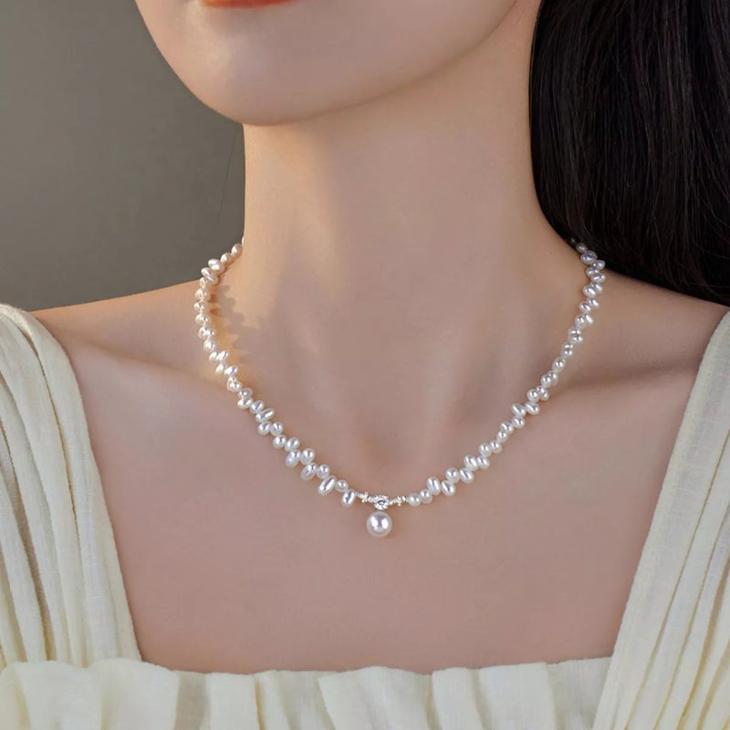 Pearl necklace worn by a model against a neutral background