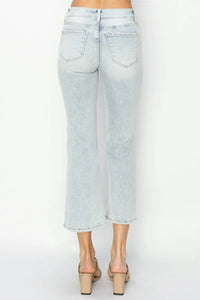 Light blue jeans worn by a person on a white background