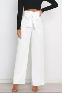White wide-leg pants with a black top on a white background