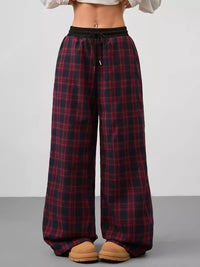 Plaid pants worn by a person on a plain background