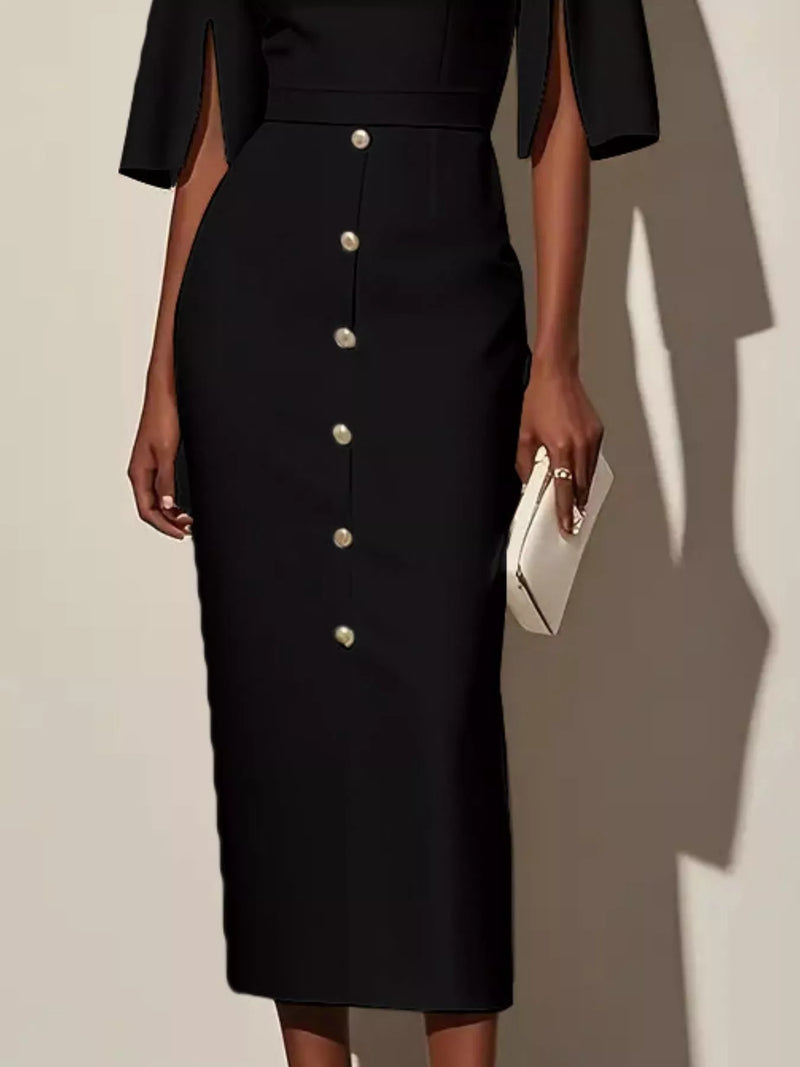 Black dress with button details worn by a person, holding a white clutch against a neutral background