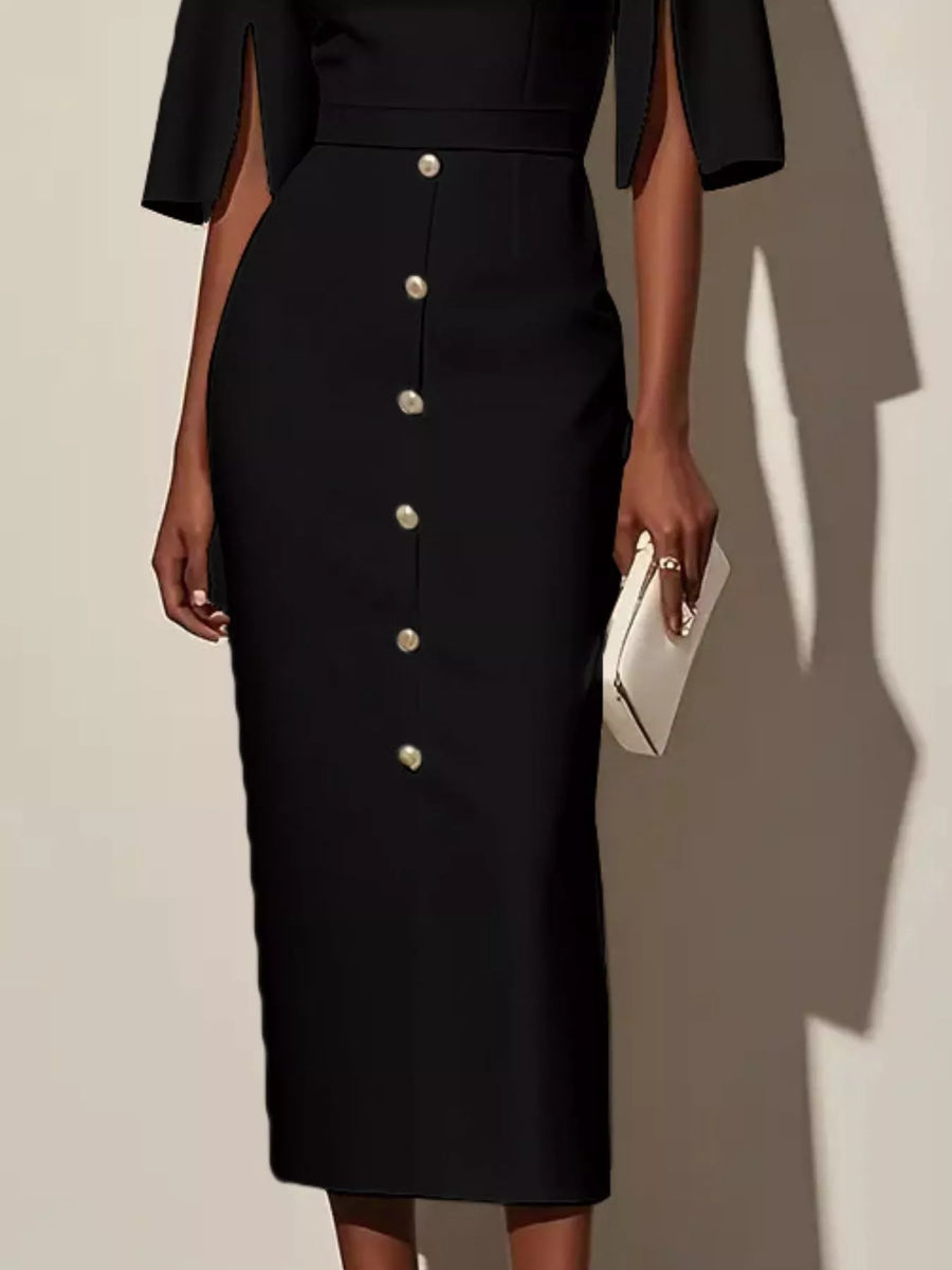 Black dress with button details worn by a person, holding a white clutch against a neutral background