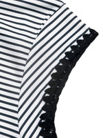 Black and white striped fabric with black lace trim on a white background