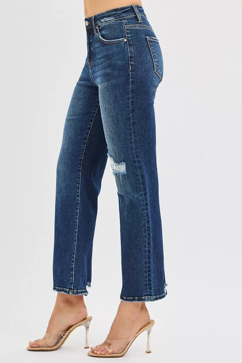 Blue jeans worn by a person on a white background