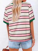 Person wearing a striped shirt with pink, green, and beige colors on a white background