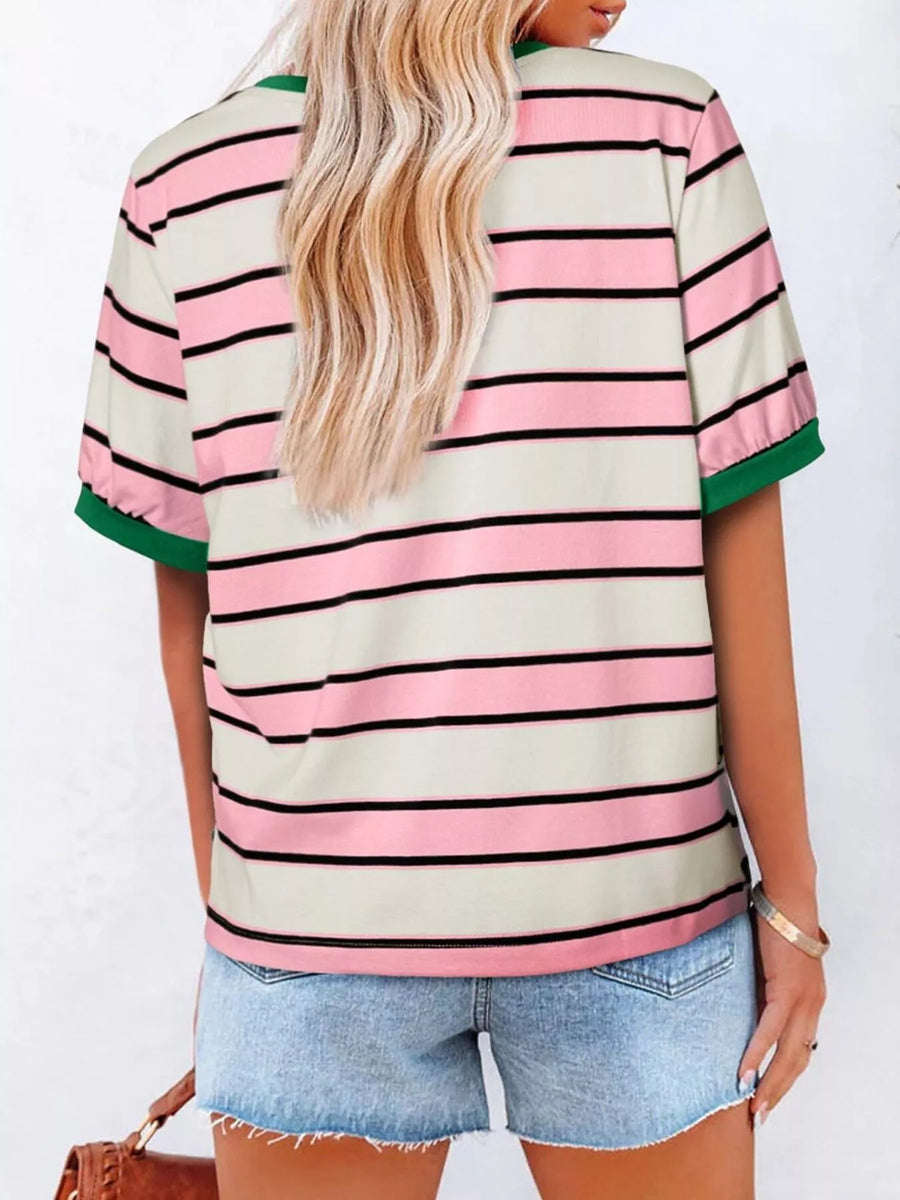 Person wearing a striped shirt with pink, green, and beige colors on a white background