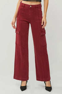 Red cargo pants worn by a person on a white background