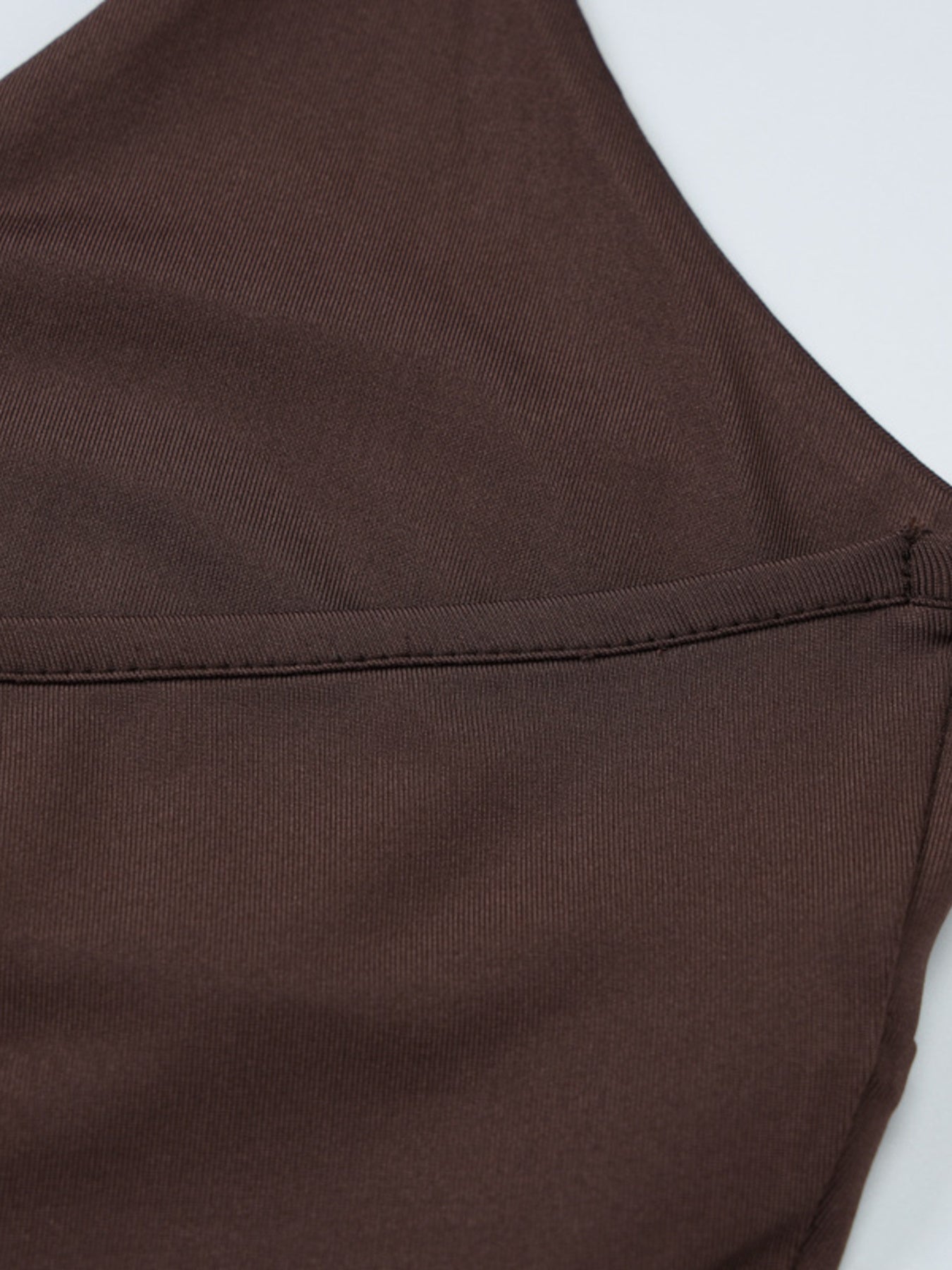 Brown fabric with a visible seam on a white background
