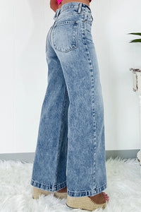 Blue jeans worn by a person on a white background