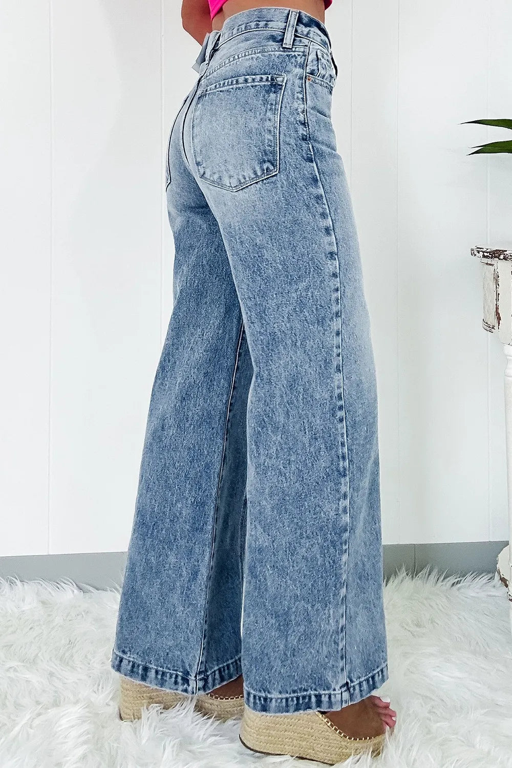 Blue jeans worn by a person on a white background