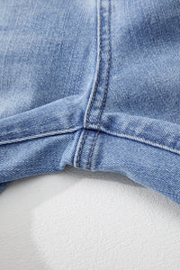 Close-up of a blue denim cap on a white background