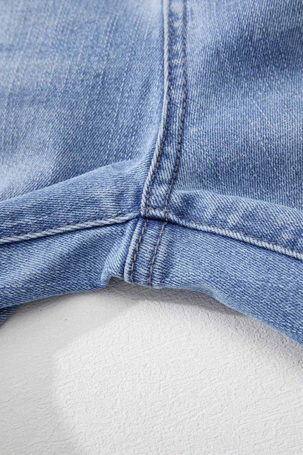 Close-up of a blue denim cap on a white background