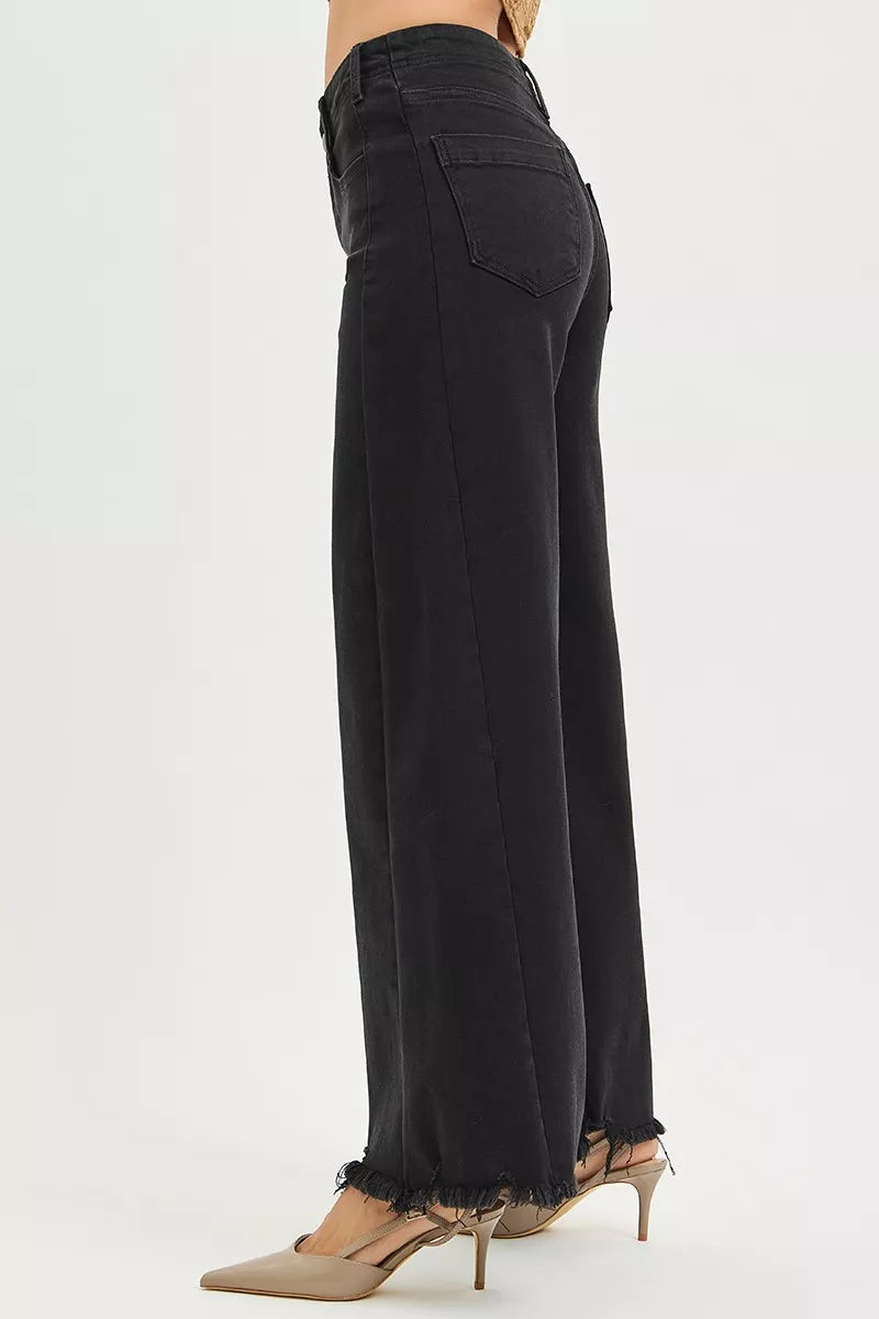 Black wide-leg pants worn by a person on a white background