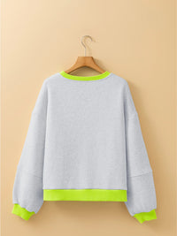 Gray sweatshirt with green trim on a beige background