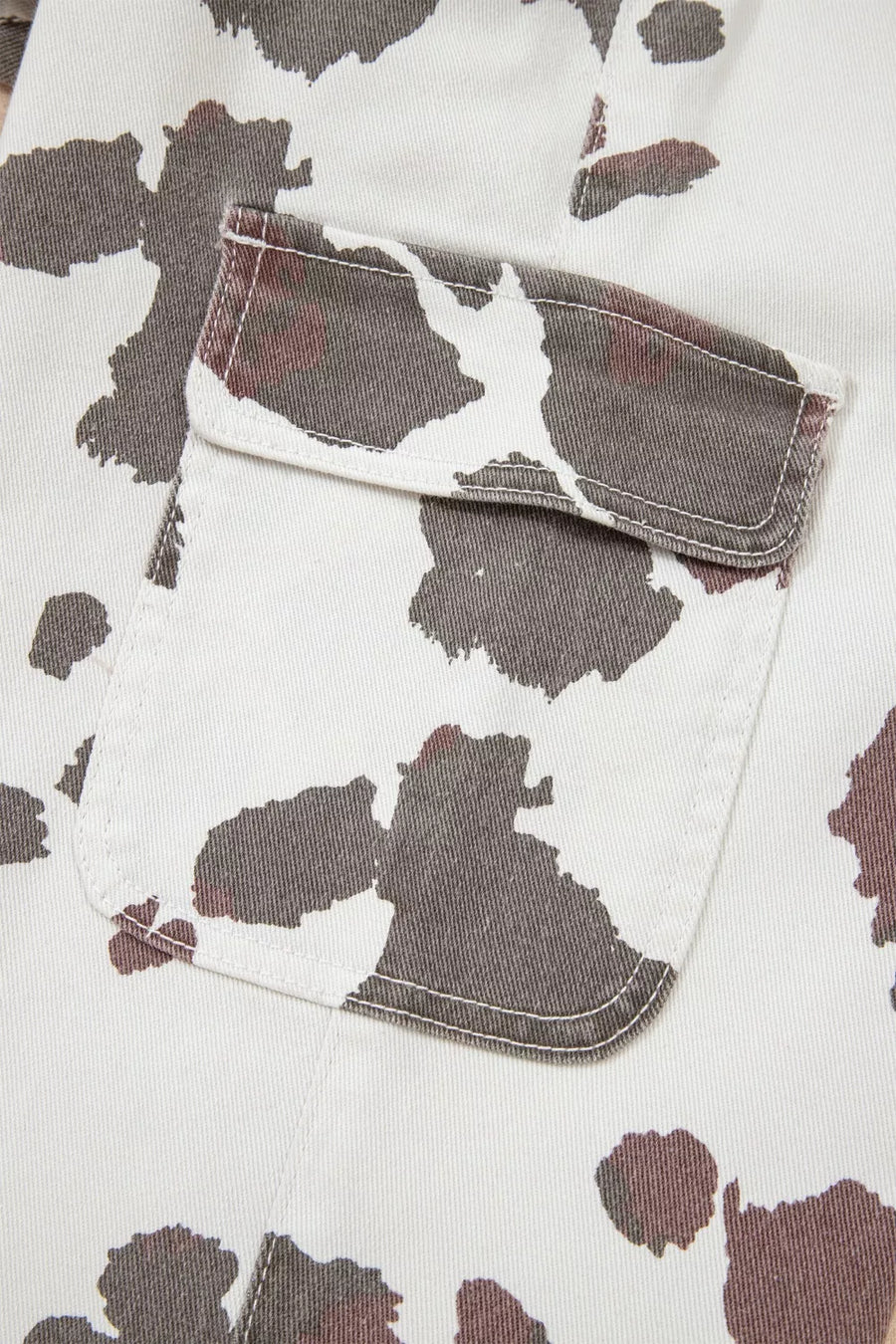Close-up of a shirt with a cow print pattern