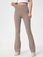 Beige flared pants worn by a person on a white background
