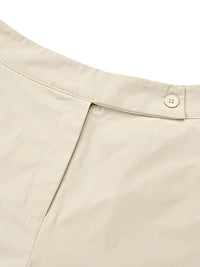 Close-up of beige pants with a button on a white background