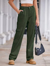 Person wearing green cargo pants with a blurred background