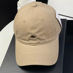 Beige cap on a black surface with a white background