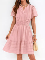 Pink dress worn by a person on a white background