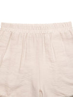 Close-up of beige shorts with a white background