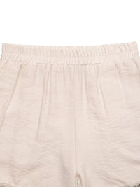 Close-up of beige shorts with a white background