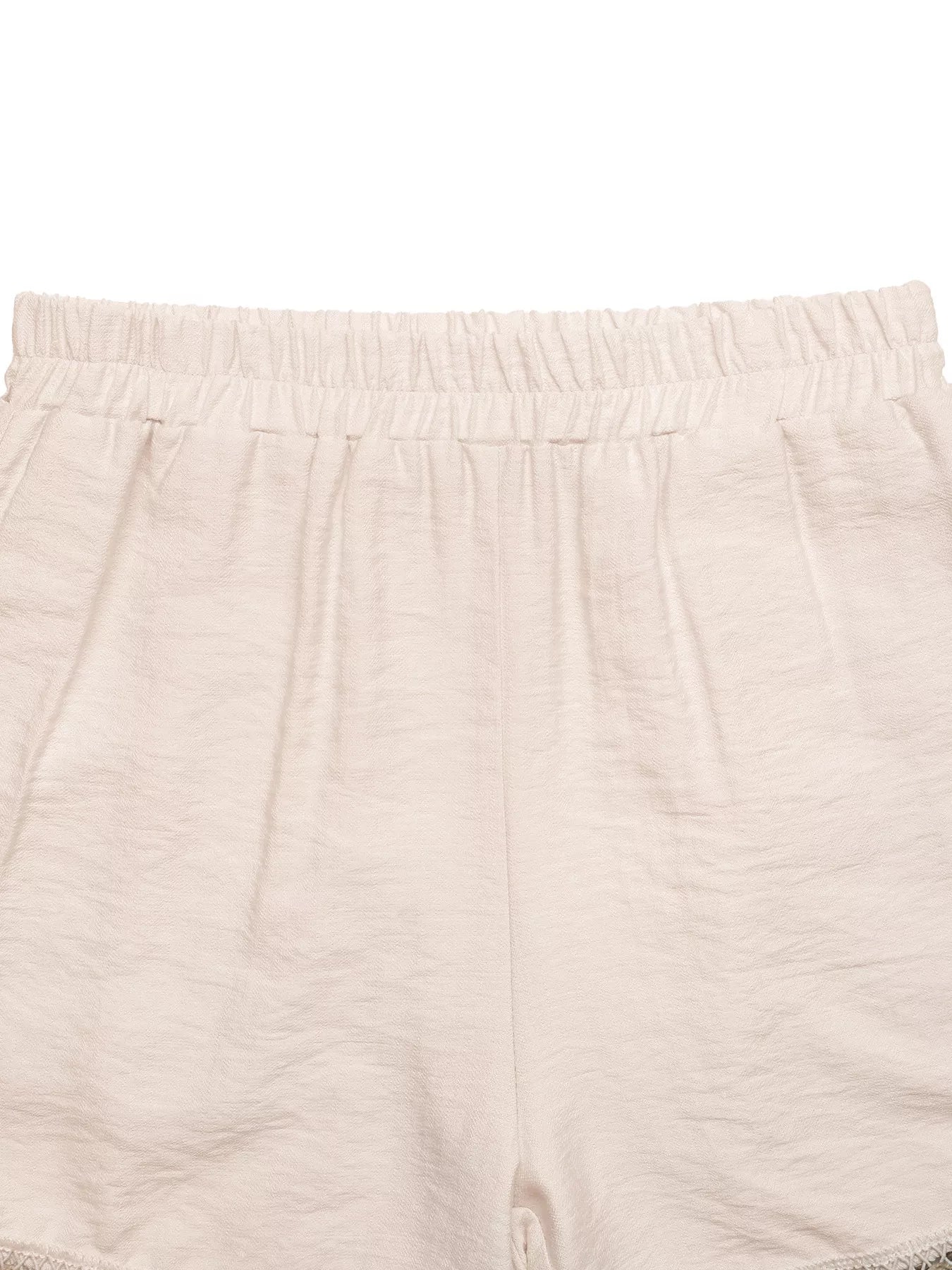 Close-up of beige shorts with a white background