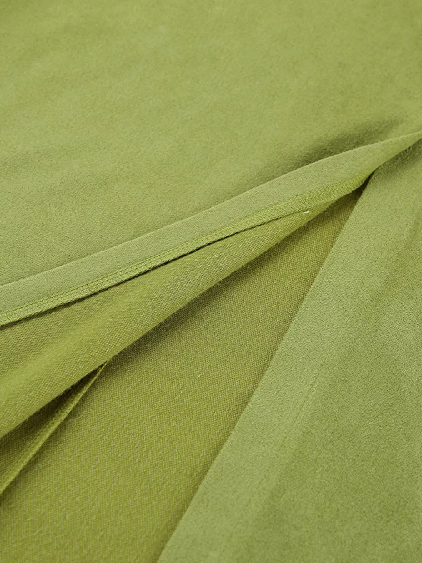 Close-up of green fabric with folds