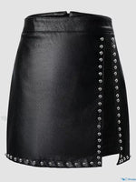 Black leather skirt with silver studs on a light gray background