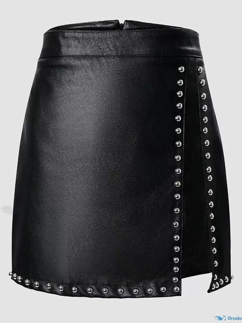 Black leather skirt with silver studs on a light gray background