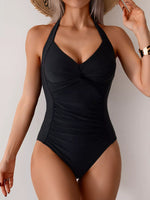 Black swimsuit worn by a model against a neutral background