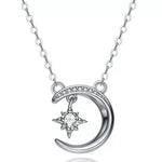Silver necklace with a crescent moon and star pendant on a white background